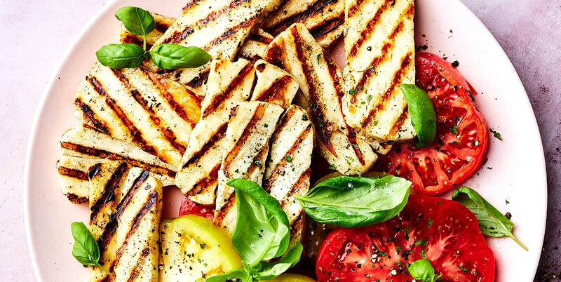 Slices of PittaS Cypriot halloumi on a dark stone surface